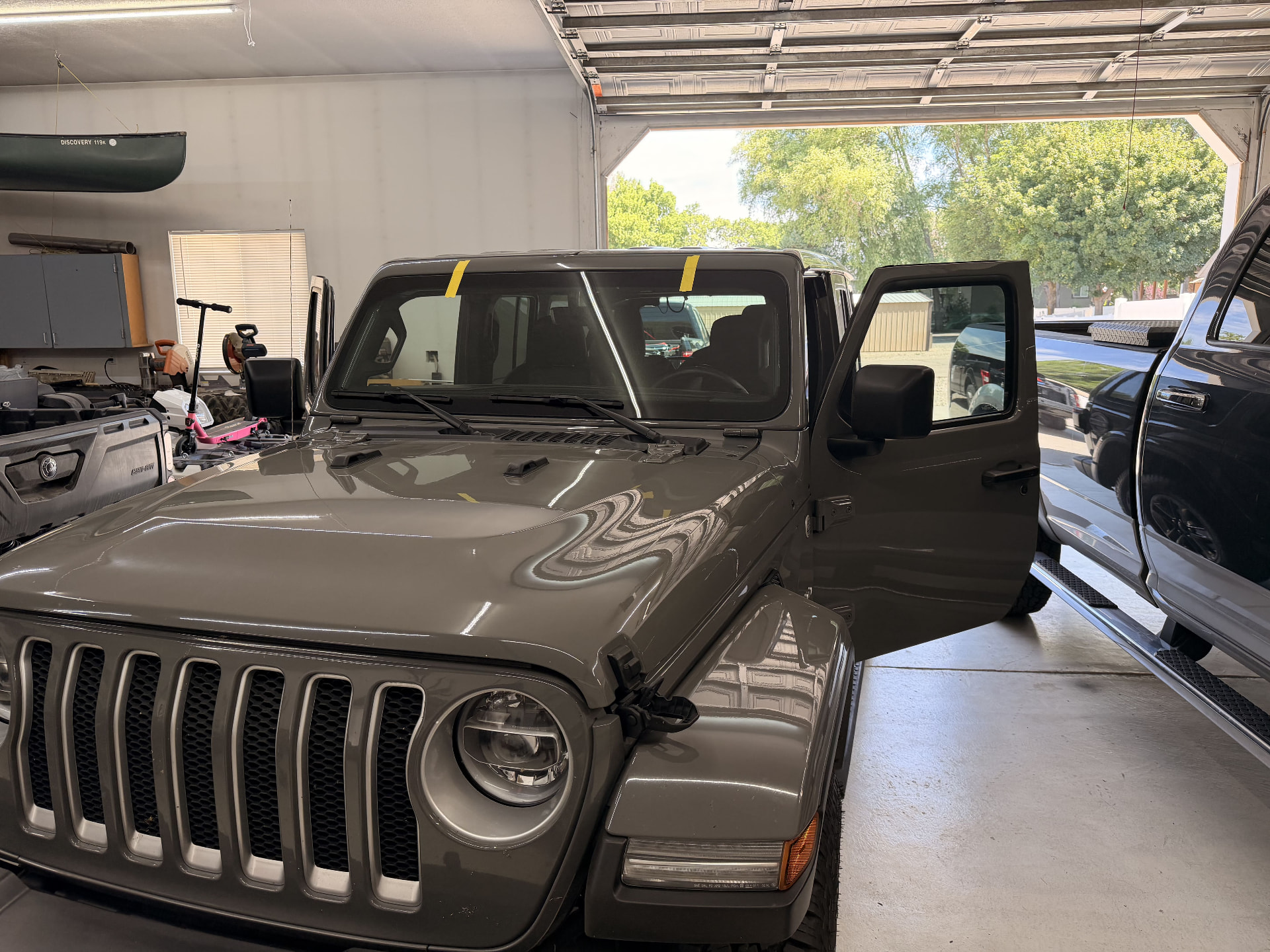 Gray Jeep Wrangler windshield replacement performed at the customer's garage